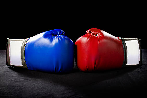 赤とブルーのボクシンググローブ、黒色の背景 - boxing glove conflict rivalry fighting ストックフォトと画像