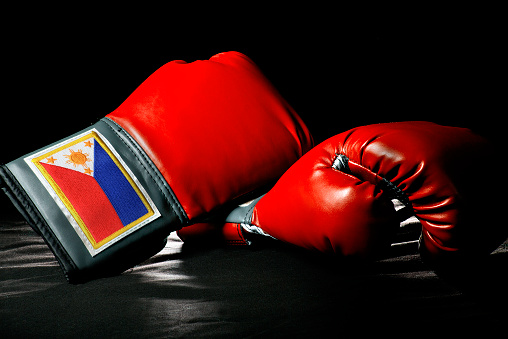 boxing gloves or martial arts gear on a black background with Filipino Flag