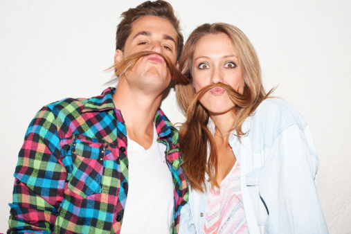 Young hipster couple pretending to have moustaches