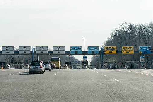 Cavaria con Premezzo, Italy - March 9, 2015:  Cars queuing in front of a toll collection area in the Italian motorway A8