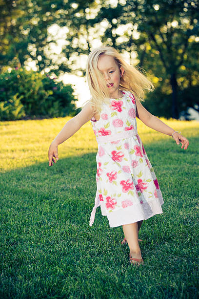 istock little girl running with sunset 466748689