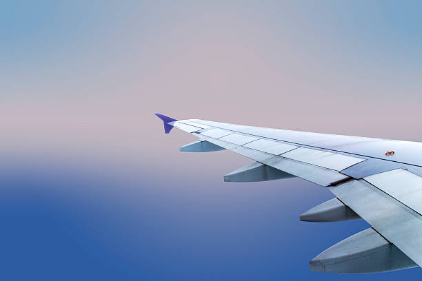 istock Wing of an airplane flying above the clouds 466748840