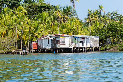 Bocas del Toro, Panama - February 27, 2015: Small rustic house built on stilts along the shore on the islands of Bocas del Toro, Panama.In a developing country many poor people live in these type of houses and rely mostly on fishing or the tourism.