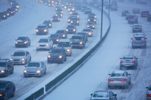 A winter storm slows traffic on the roads.