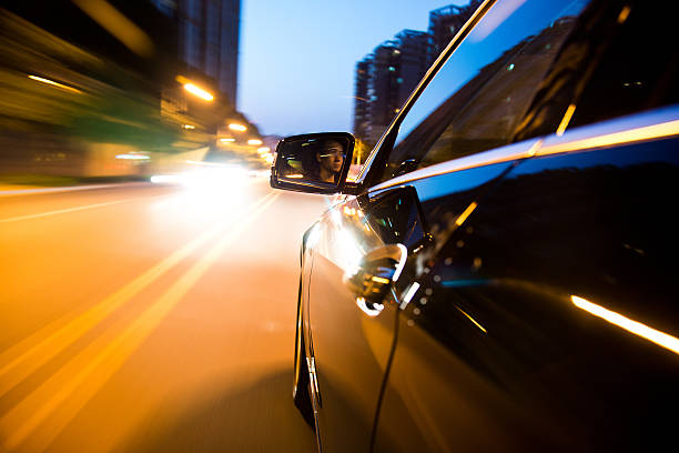 istock Car driving at night with flashes everywhere 466750034