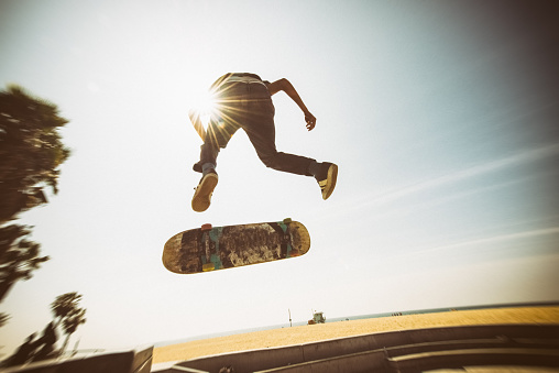 African american teenager Skateboarding Venice Beach Skatepark in Los Angeles, California. USA.