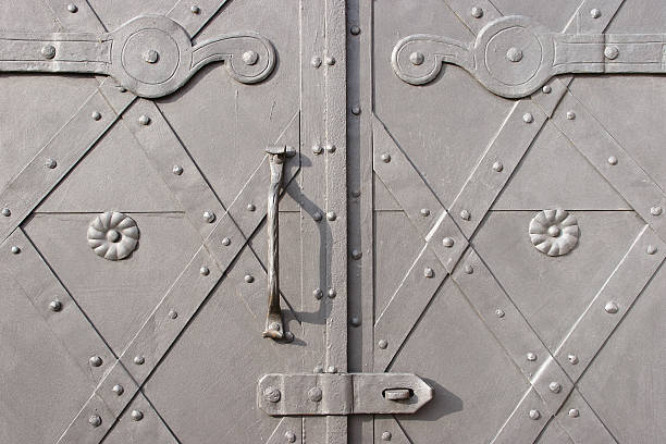 Metal door with a handle Close-up of a metal door with a handle riveting stock pictures, royalty-free photos & images