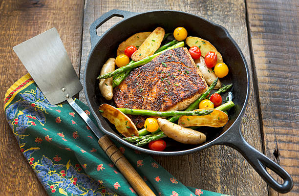 istock Roast Salmon and Vegetables in a Cast-Iron Pan. 466750952