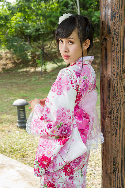 istock Geisha leaning against wodden pillar 466751230