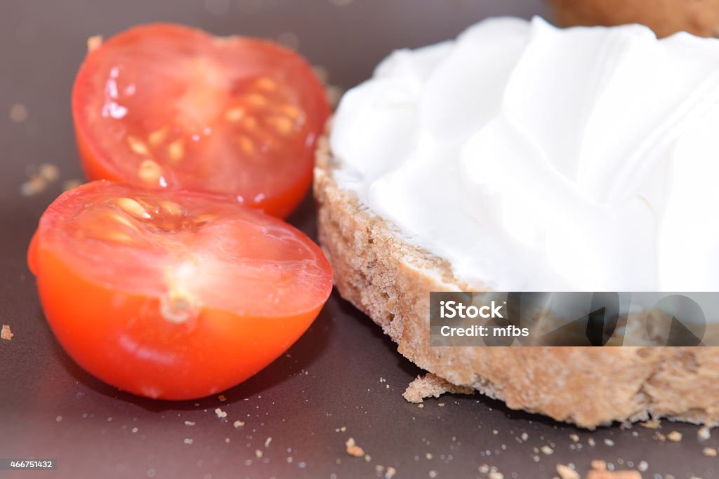 Slice of bread with cream cheese. Slice of bread with cream cheese on a chopping board. 2015 Stock Photo