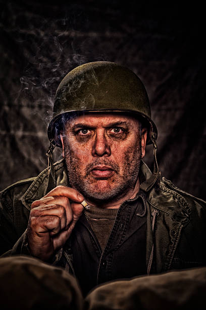 istock War Worried Vintage Army Soldier holding a cigarette 466757476