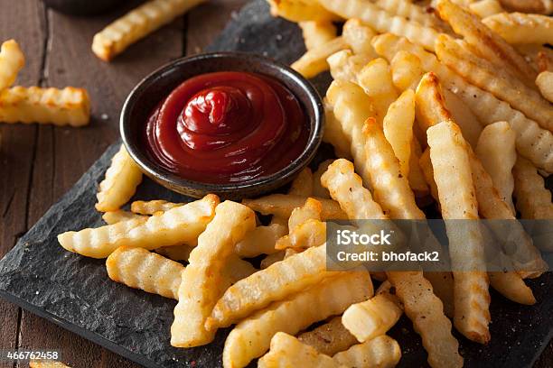 Unhealthy Baked Crinkle French Fries Stock Photo - Download Image Now - French Fries, Scalloped - Pattern, 2015