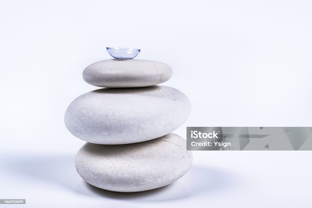 contact lens on a pile of white stones contact lens on a pile of white stones with a white background Accessibility Stock Photo
