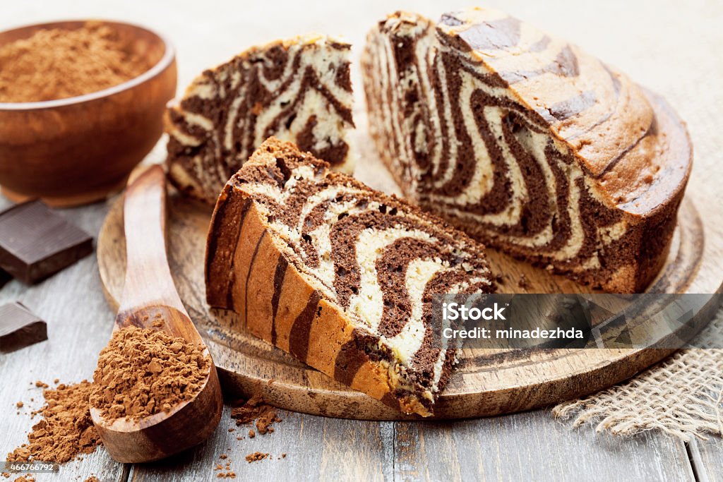 Cake with cocoa  powder Cake with cocoa  powder on the wooden table Cake Stock Photo