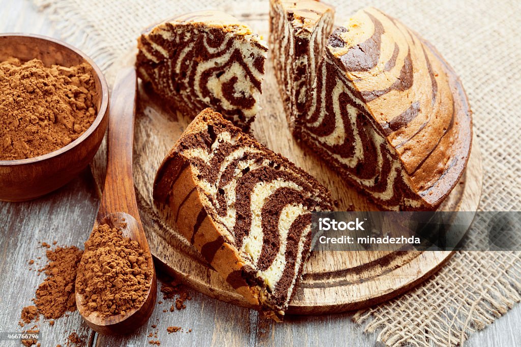 Cake with cocoa  powder Cake with cocoa  powder on the wooden table 2015 Stock Photo