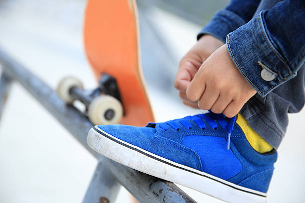 istock skateboarder tying  shoelace 466772546