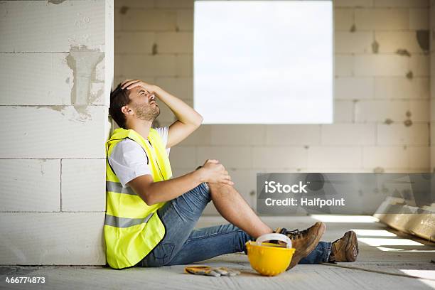 Male Construction Worker Agonizes Over Accident At Worksite Stock Photo - Download Image Now