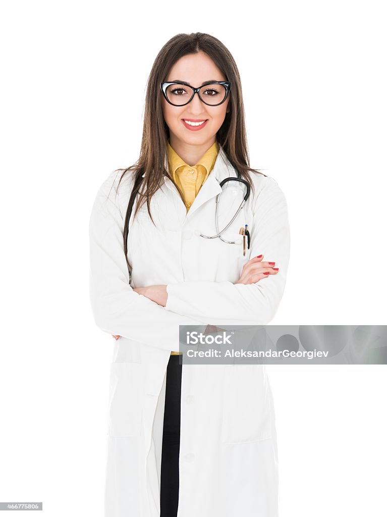 Young Attractive Female Doctor how Smiling and Wearing Medical Uniform Young Attractive Female Doctor how Smiling and Wearing Medical Uniform and posing with crossed arms. Isolated on White. 2015 Stock Photo