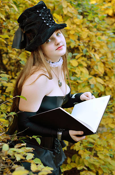 istock Cosplayer with a book in the autumn park 466780015