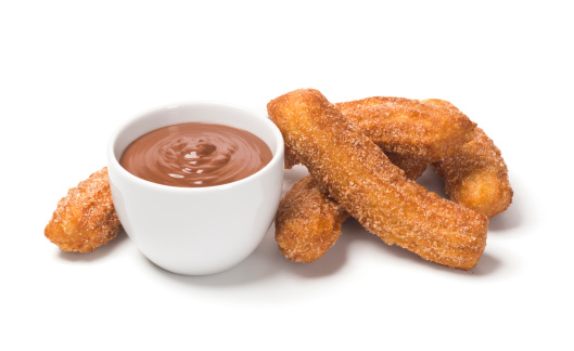 Churros are sticks of fried dough (sometimes called Spanish doughnuts) rolled in cinnamon and sugar that originate from Spain. They are frequently served with a mug of hot chocolate. This 
