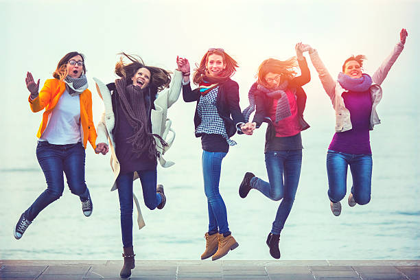 istock Young happy friends jumping, seaside, fun, carefree 466784048