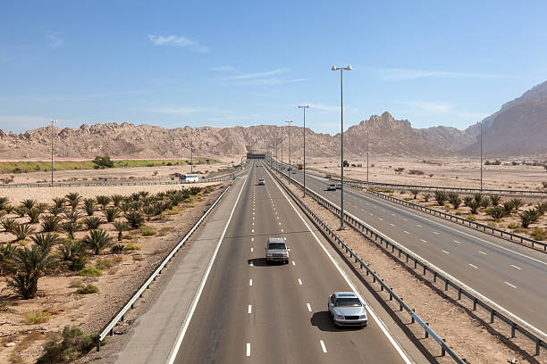 Highway in Al Ain, UAE Highway at the Jebel Hafeet mountains in Al Ain, Emirate of Abu Dhabi, UAE jebel hafeet stock pictures, royalty-free photos & images