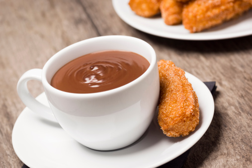 Churros are sticks of fried dough (sometimes called Spanish doughnuts) rolled in cinnamon and sugar that originate from Spain. They are frequently served with a mug of hot chocolate. This 