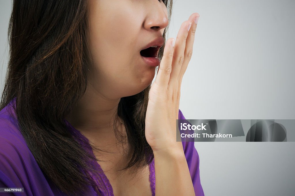 Yawning Yawning tired woman Bad Breath Stock Photo