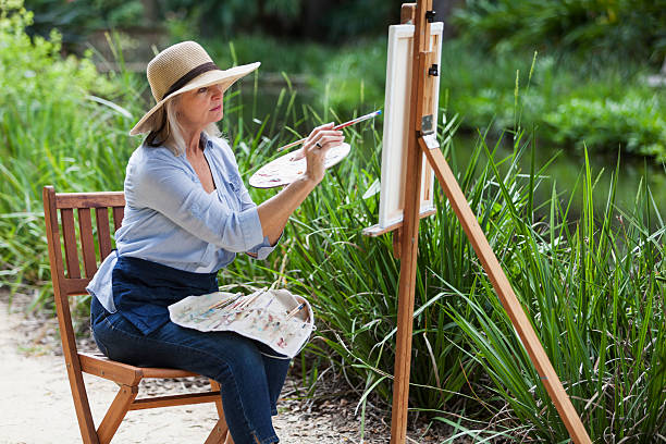 istock Artist painting nature on canvas 466794876