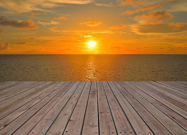 istock Wooden platform beside tropical sea with sunrise 466794942