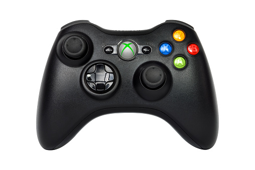 Sao Paulo, Brazil - March 13, 2015: The wireless gamepad for the Xbox 360, a home video game console produced by Microsoft, isolated on white background.