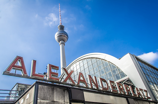 Sign on the Alexanderplatz Hauptbahnhof with the famous TV tower in the background,