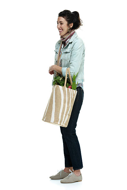 istock Smiling female holding vegetable bag 466798274