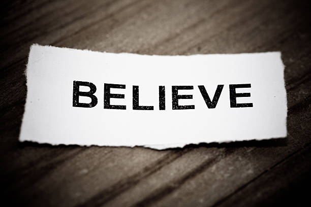 istock "Believe" text on wood background 466803797
