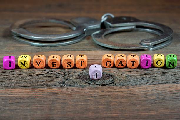 istock Sign INVESTIGATION and Handcuffs 466804590