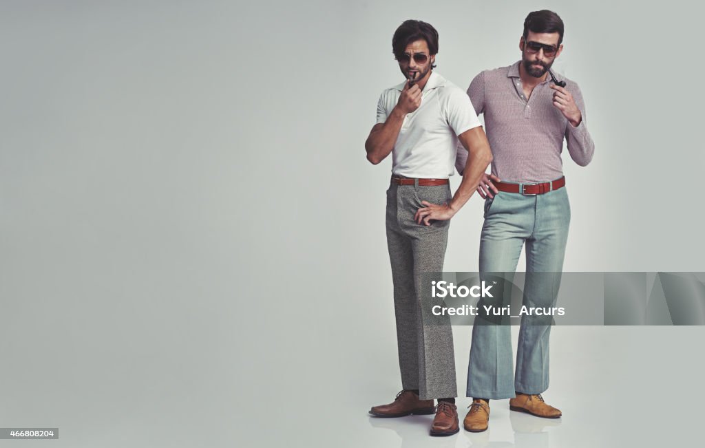 They've got far out style Studio shot of two men standing together while wearing retro 70s wear and smoking pipeshttp://195.154.178.81/DATA/i_collage/pi/shoots/782690.jpg 1970-1979 Stock Photo