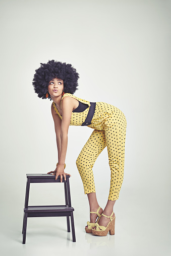 A young woman wearing a 70s retro jumpsuit while pouting and striking a posehttp://195.154.178.81/DATA/istock_collage/0/shoots/782690.jpg
