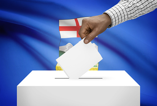 Voting concept - Ballot box with Canadian province flag on background - Alberta