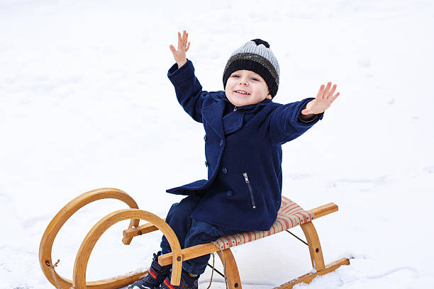 istock Lovely little boy on ancient sledge, winter day 466811995