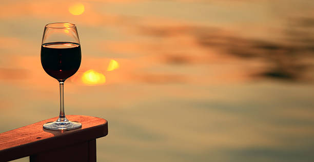 istock Red Wine Glass By a Lake at Sunset 466813742