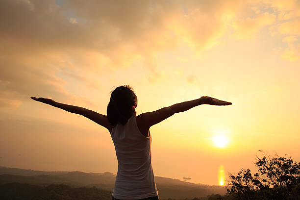 istock cheering woman on mountain peak 466815356