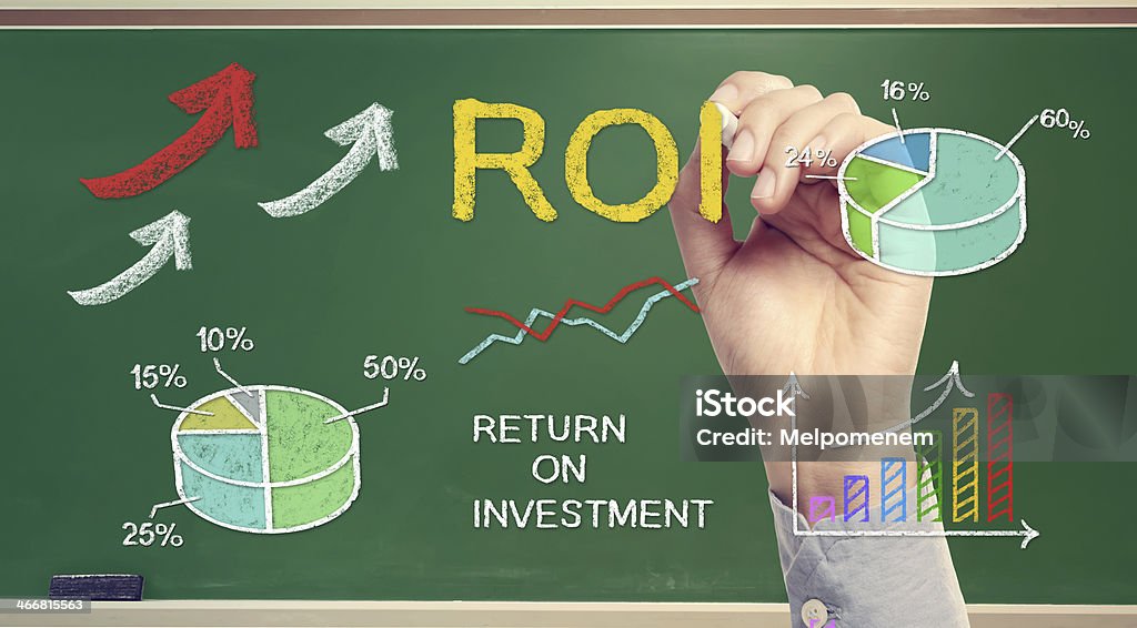 Hand drawing ROI (return on investment) Hand drawing ROI (return on investment) on chalk board Arrival Stock Photo