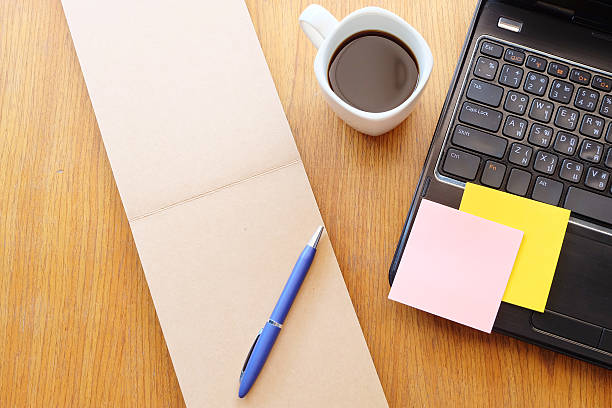 istock note book and laptop on wooden table with coffee 466815752