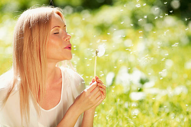 istock Girl blow on dandelion 466816452