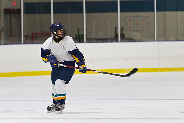 istock Female ice hockey player skating during a game 466816649