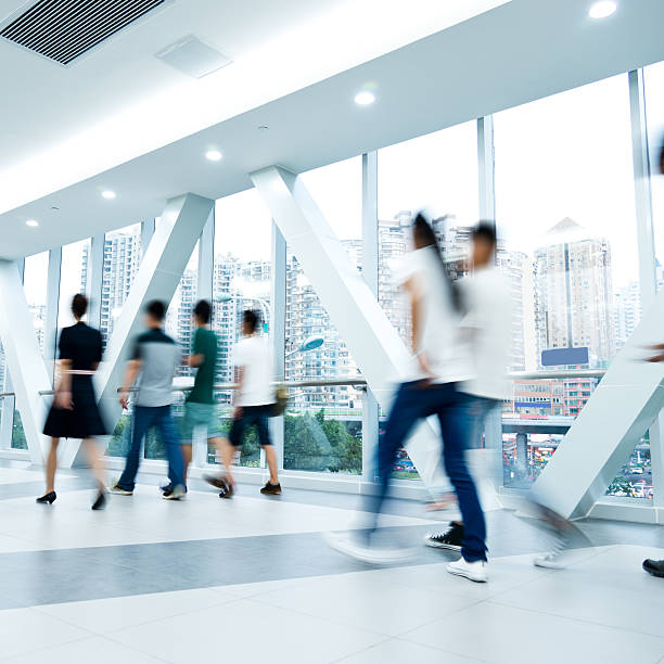 istock Six people walking in a building illustrating blurred motion 466821082