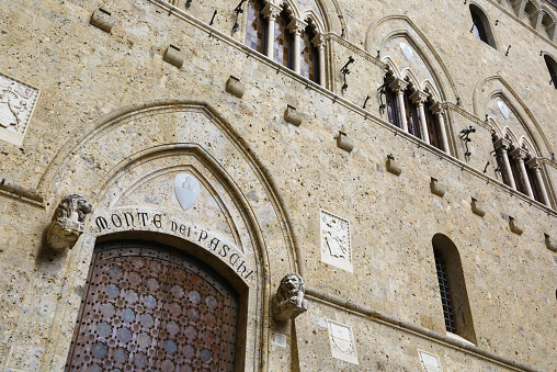 Siena, Italy - March 14, 2015: The entrance of Mone dei Paschi headquarters,