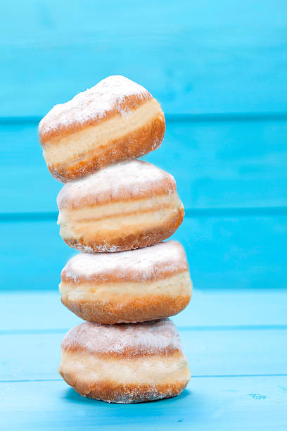 cruller cruller on blue background beignet stock pictures, royalty-free photos & images