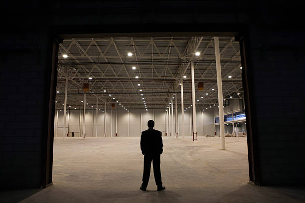 istock Businessman Standing At Warehouse Entrance 466825511