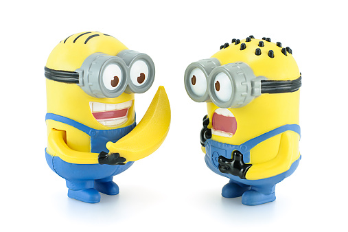 Bangkok,Thailand - February 17, 2014: Minion Dave give banana to Minion figure toy character from Despicable Me 2 movie. There are plastic toy sold as part of the McDonald's Happy meals.